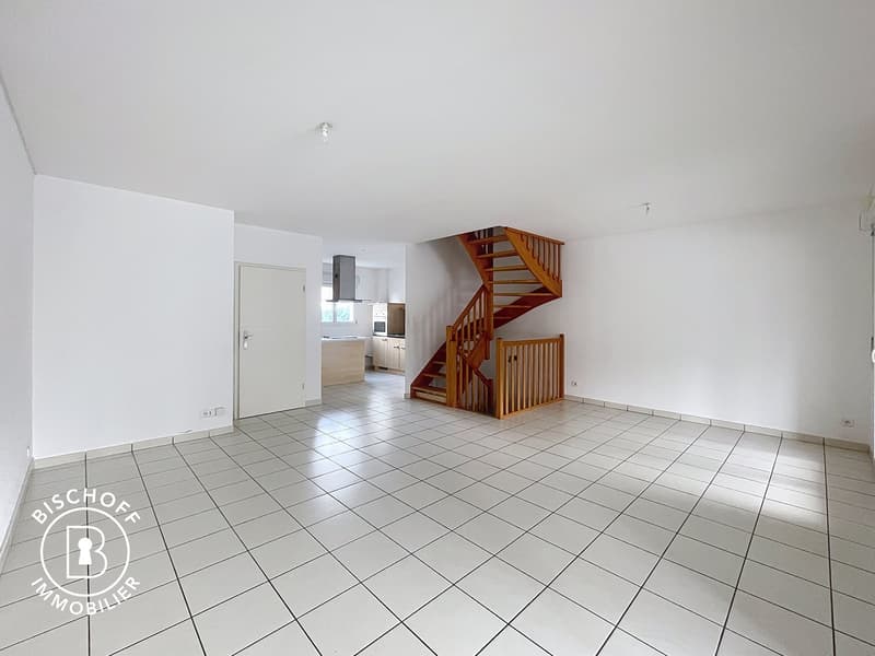 empty room, white tiled floor, wooden staircase, open doorway, and a cabinet