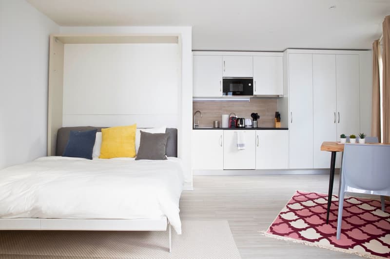 single bed, white furniture, kitchen, desk, microwave, faucet