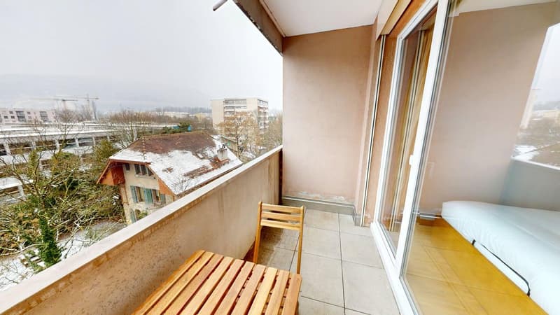 wooden table, chair, glass walls, small bedroom