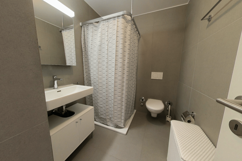 White sink, mirror, white cabinets, white shower curtain, toilet