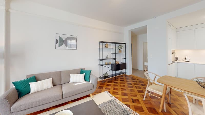 modern and cozy living room with wooden floor, gray sofa, wooden table, white chairs, wall picture, wooden floor