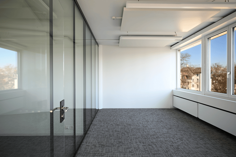empty room, glass walls, carpeted floor, white walls, large windows