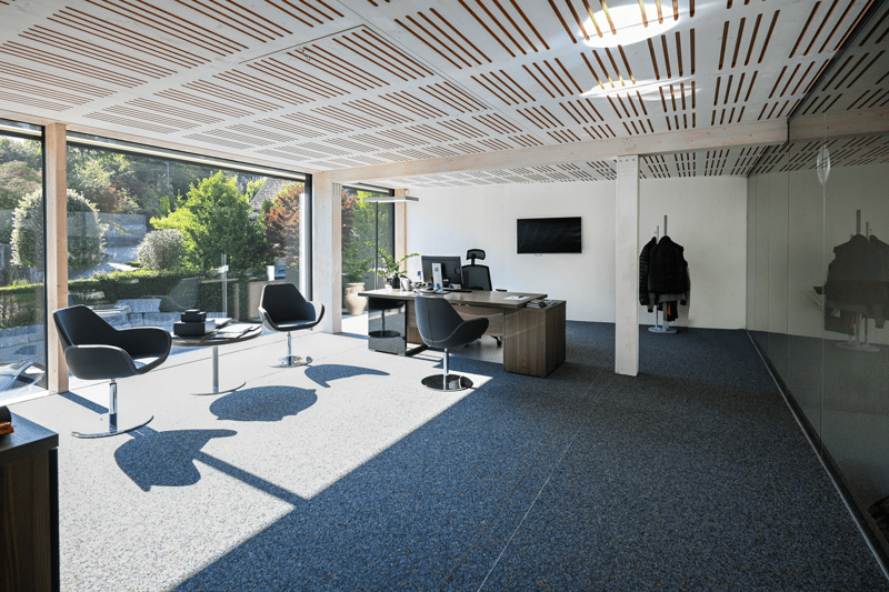Modern office room with desk, two black swivel chairs, table, large glass window, carpet, tv