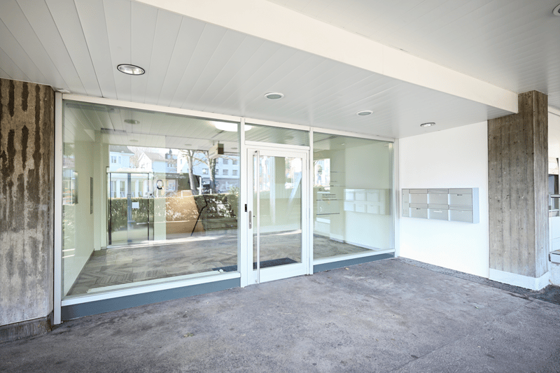 modern house, glass doors, concrete walls, mailbox on the wall
