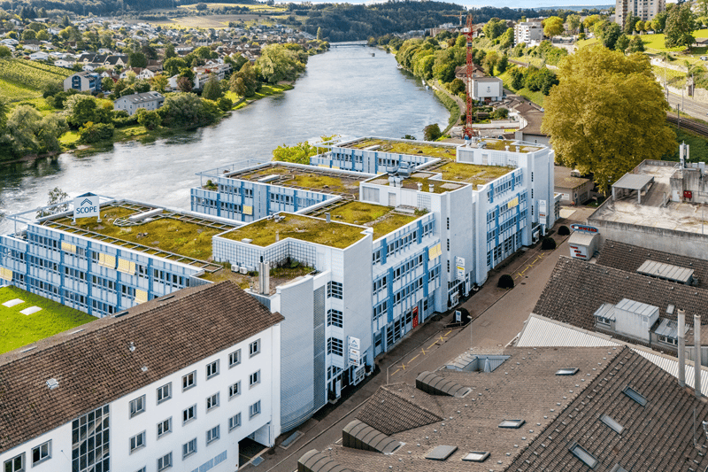 multi-storey building, green rooftop, modern architecture, river view