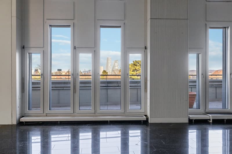 empty room with large windows and doors, balcony outside, shiny floor