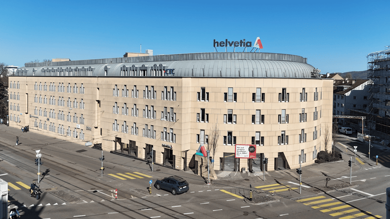 4 story building, grey exterior, windows, logo sign for Helvetia