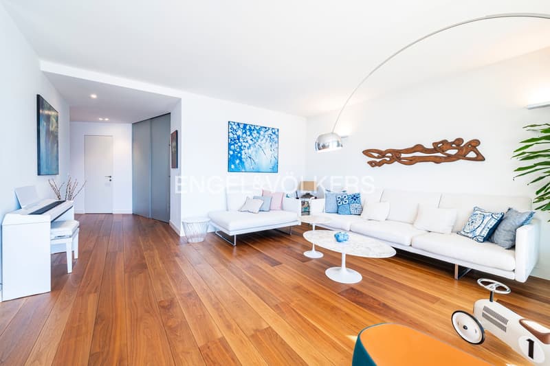 hardwood floor, 2 couches, coffee tables, piano, wall art, lamps