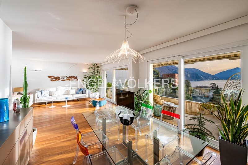 wooden floor, large windows, glass doors leading to balcony, couch, coffee table, dining table, hanging lamp, plants
