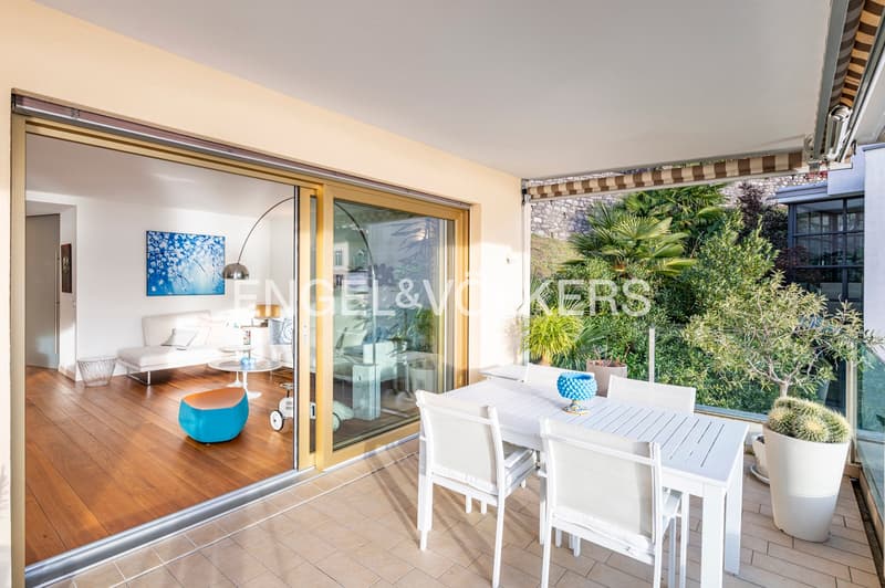 Outdoor dining area, balcony, glass sliding doors, white furniture, outdoor plants, city view
