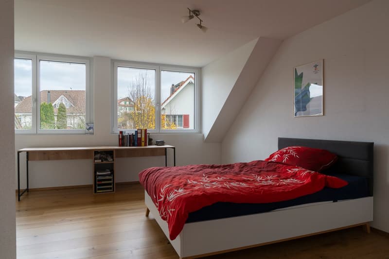 Bedroom with desk, bed, and three large windows