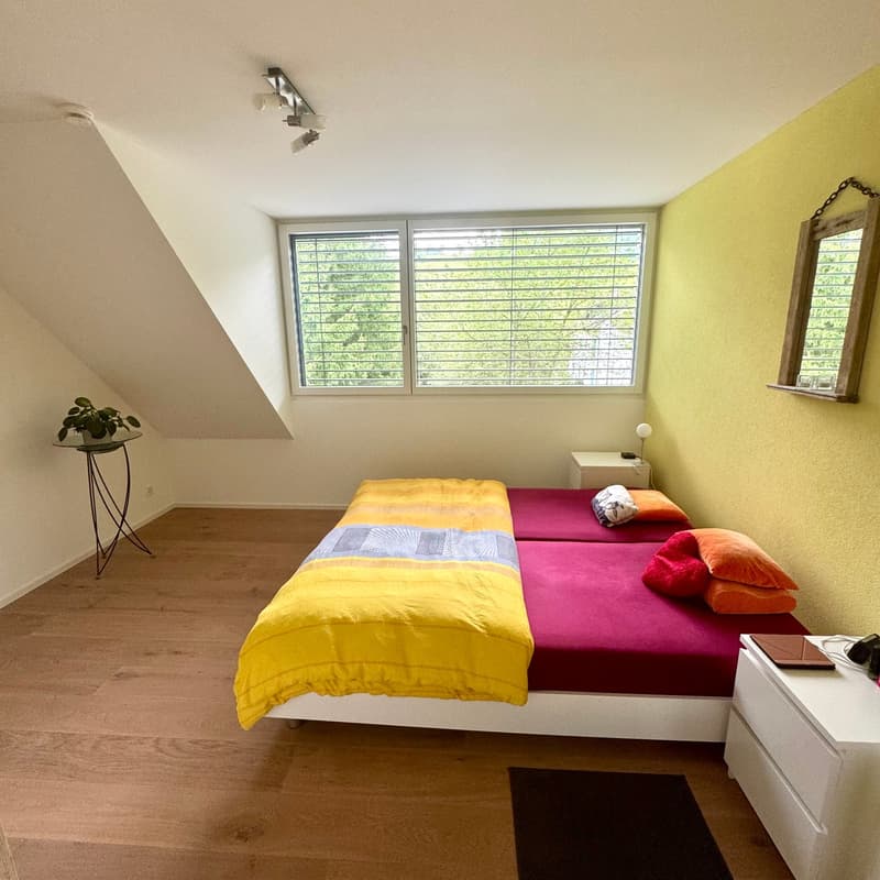 wooden floor, yellow walls, window with blinds, two single beds pushed together, nightstands, pillows, potted plant, carpet