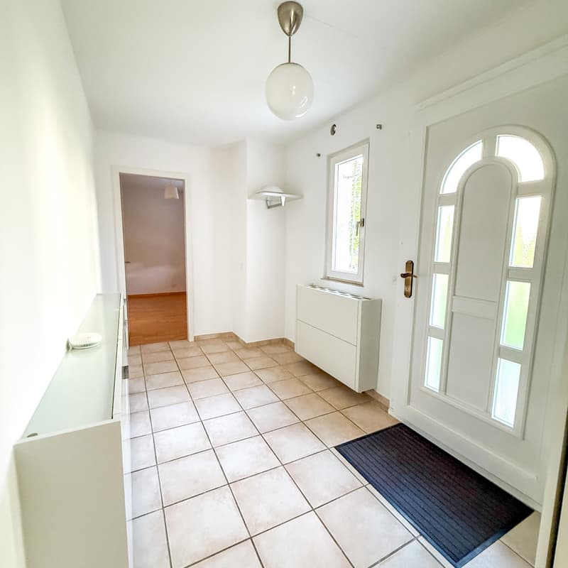 white walls, tiled floor, white ceiling, white door, radiator, entrance mat