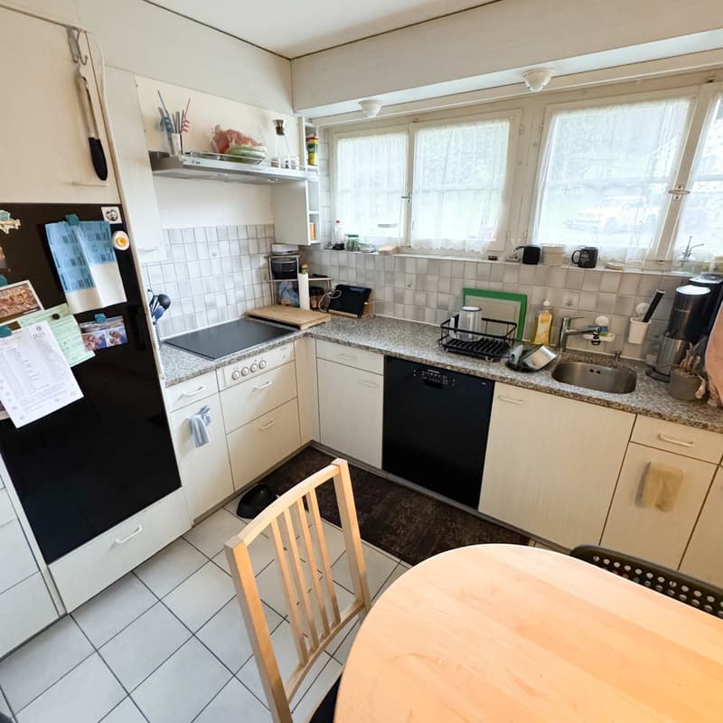 Countertops, kitchen appliances, table and chairs, tiled floor, cabinets, natural lighting