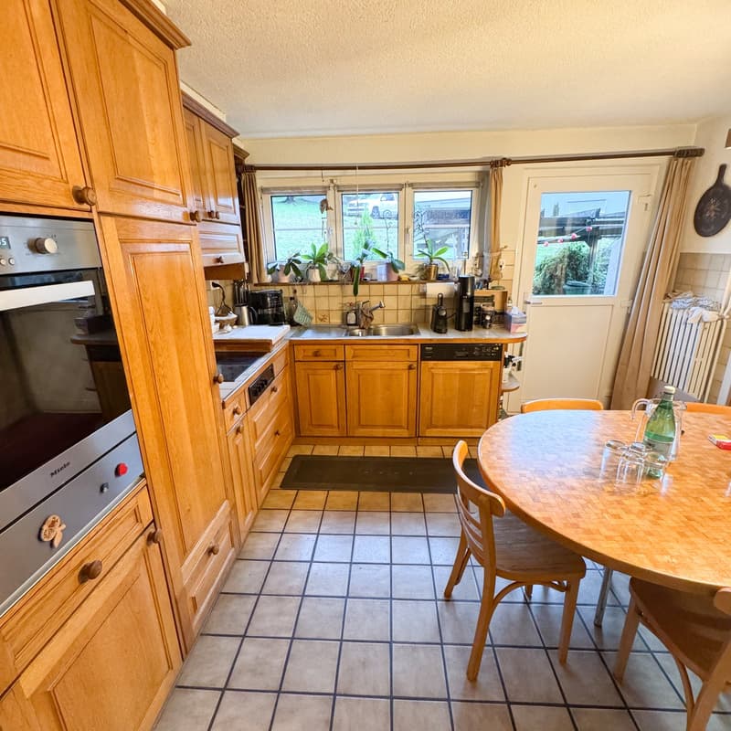 open kitchen with large oven, dishwasher, and dining area with large table