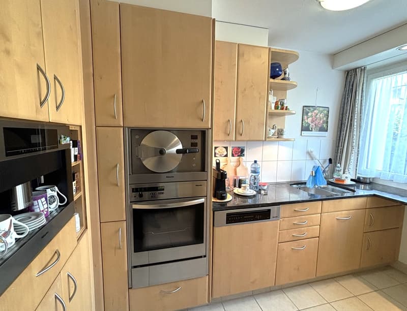 Modern kitchen, wooden cabinets, stainless steel appliances, dishwasher, microwave, kitchen island, sink, faucet, window