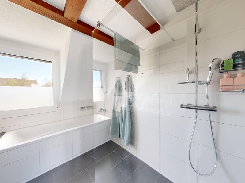 white tiles, bathtub, glass shower enclosure, shower head, towel rack, window