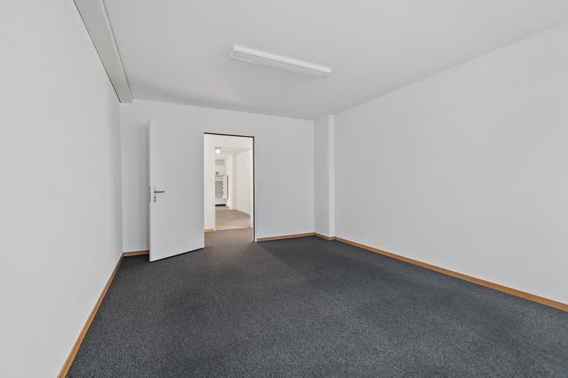 empty room, white walls, gray carpet, opened door leading to another room