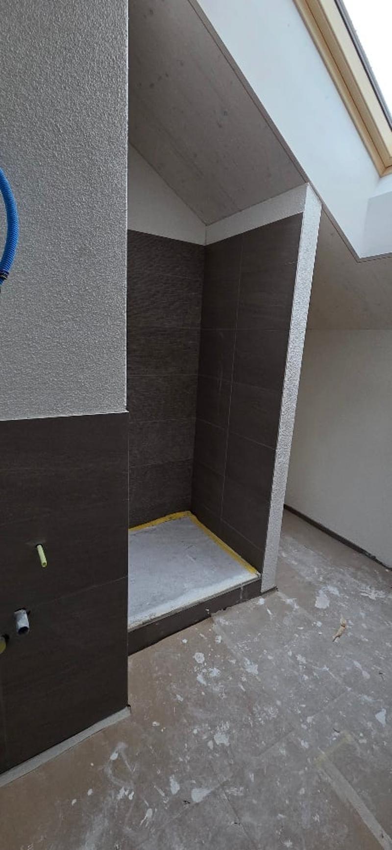 unfinished bathroom with tile and window