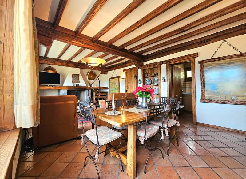 wooden ceiling, tile floor, fireplace, dining table with chairs, sofa, TV