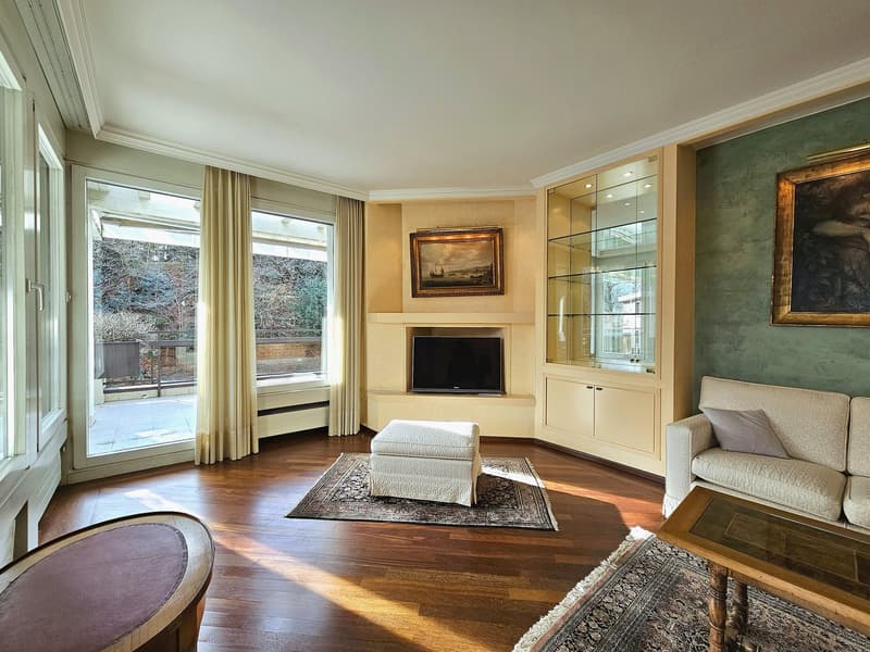 modern style living room, large windows, balcony, white fireplace, TV, couches, coffee table, side table, carpet, framed pictures on wall