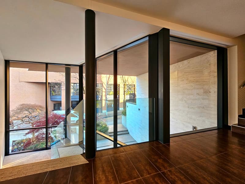 large glass walls, wooden floor, modern design, view of outside