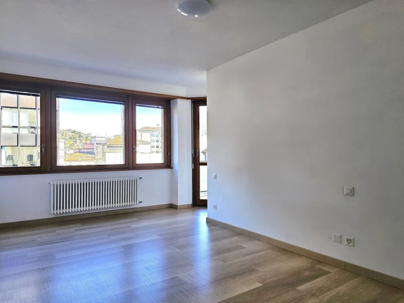 empty room, wooden floor, white walls, large windows, white radiator, ceiling light