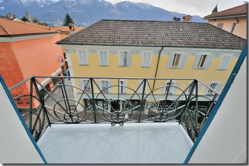 Metal railings, unobstructed view, tiled floor, mountain backdrop