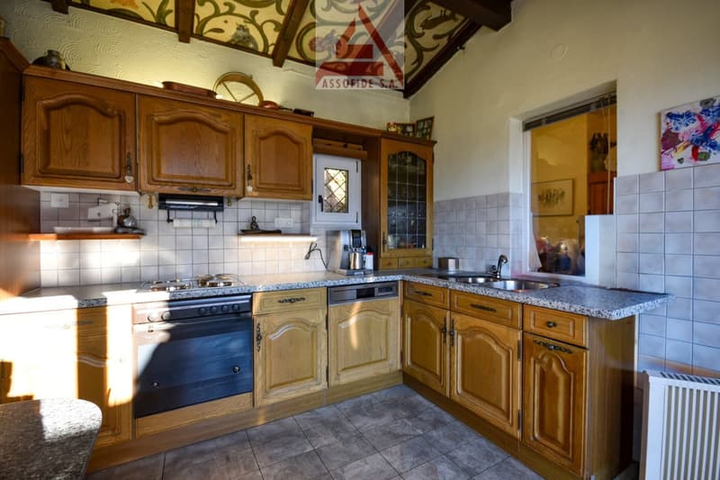 modern kitchen with wooden cabinets, granite countertops, oven, dishwasher, sink, and tiled flooring
