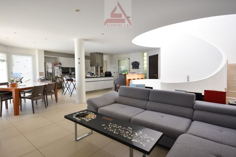 modern interior design, dining table, couch, tiled flooring, white walls, white kitchen cabinet, fridge, dartboard, staircase, windows