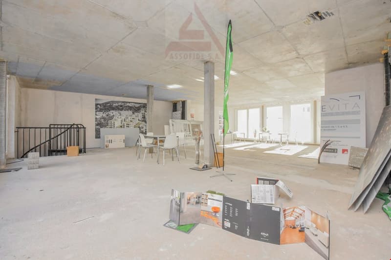 Empty room with chairs, tables, and a staircase.