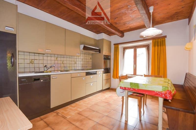 modern kitchen with tile flooring, cabinets, dishwasher, sink, oven, window, table, chairs, lamp