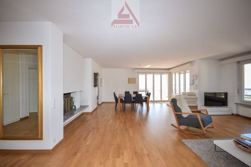 Fireplace, hardwood floor, large windows, dining area, glass door, table and chairs, television, rocking chair, couch, rug, table