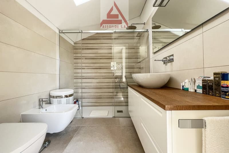 modern bathroom with shower, sink, toilet, and vanity