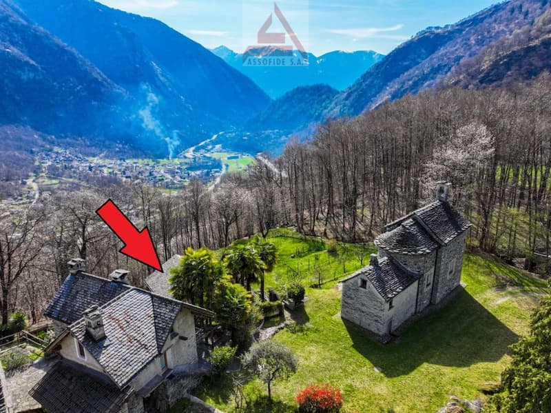 Stone house with a slate roof, located in a mountainous area with a beautiful view of the valley and mountains