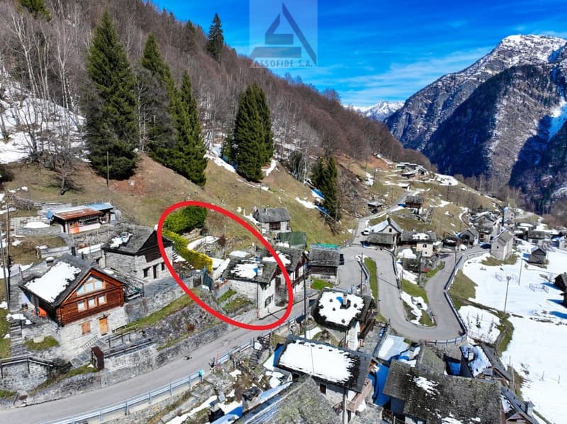 Mountain house, stone walls, snow-covered roof, surrounded by trees and mountains, road leading to the house