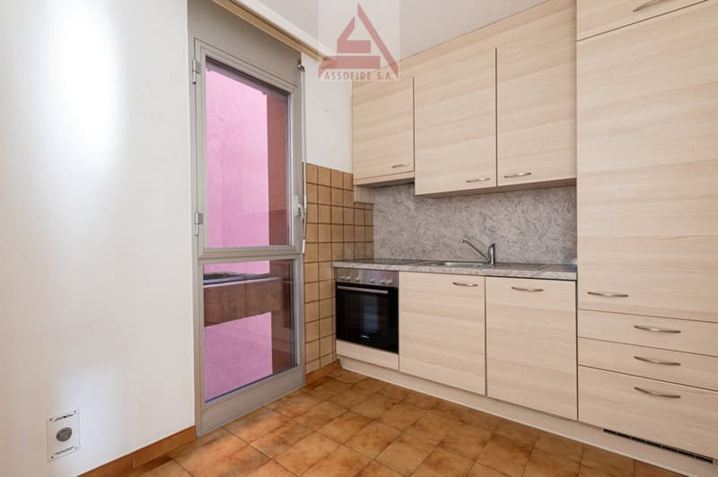 kitchen with oven, sink, cabinets, tiled floor, glass door