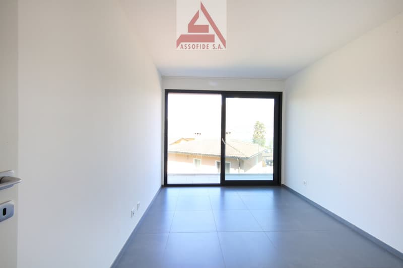 empty room, white walls, gray floor, sliding glass door, balcony