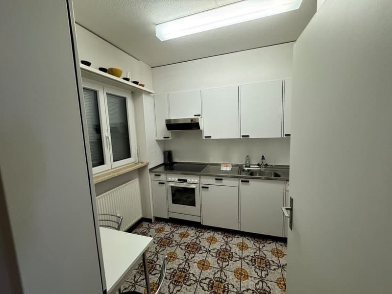 White kitchen, gas stove, dishwasher, kitchen hood, white cabinets, white tiled floor