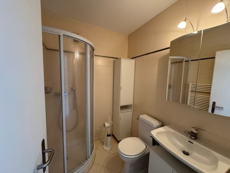 Bathroom with shower, toilet, sink, mirror, and cabinet