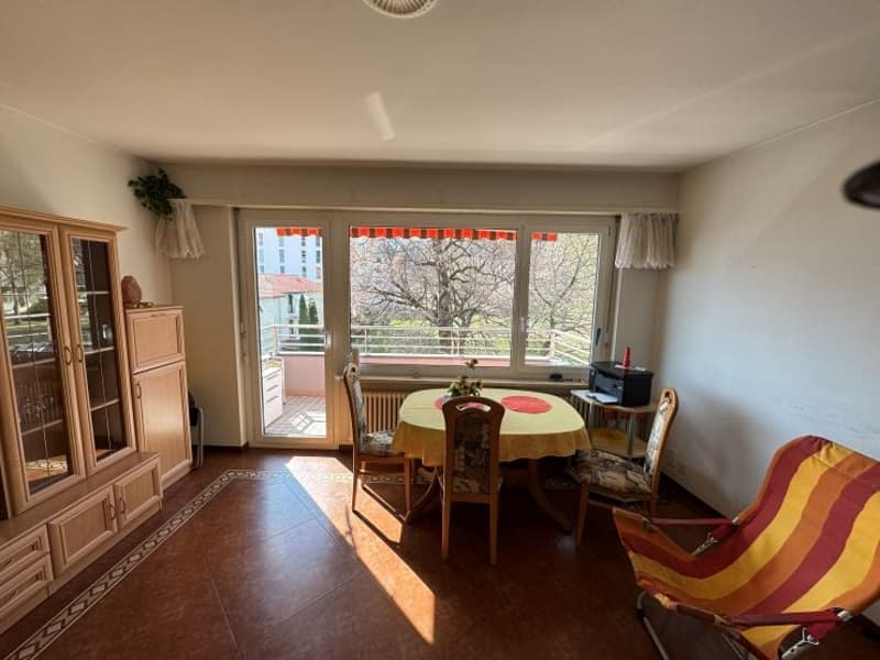 dining room with table, chairs, cabinet, balcony, and a chair