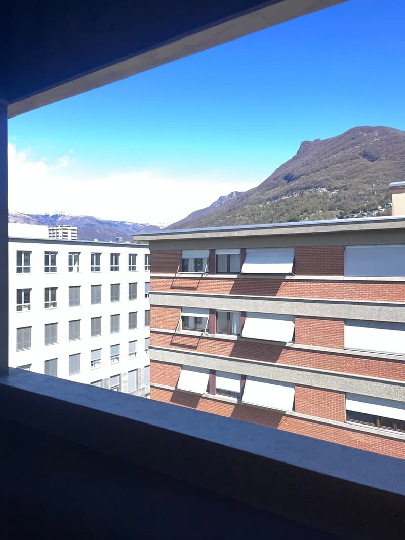 View from balcony of a building with mountains in the background