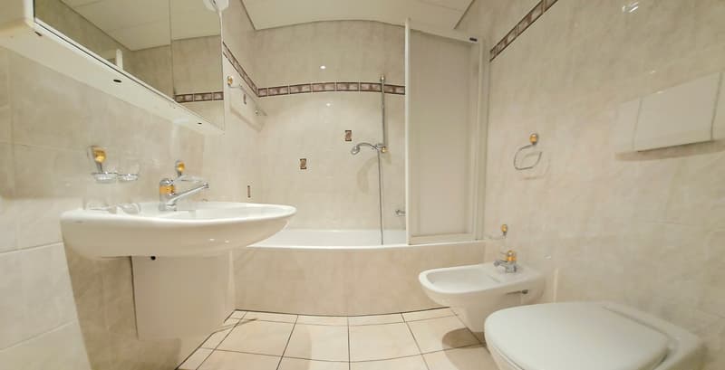 Bathroom with bathtub, sink, bidet, and toilet