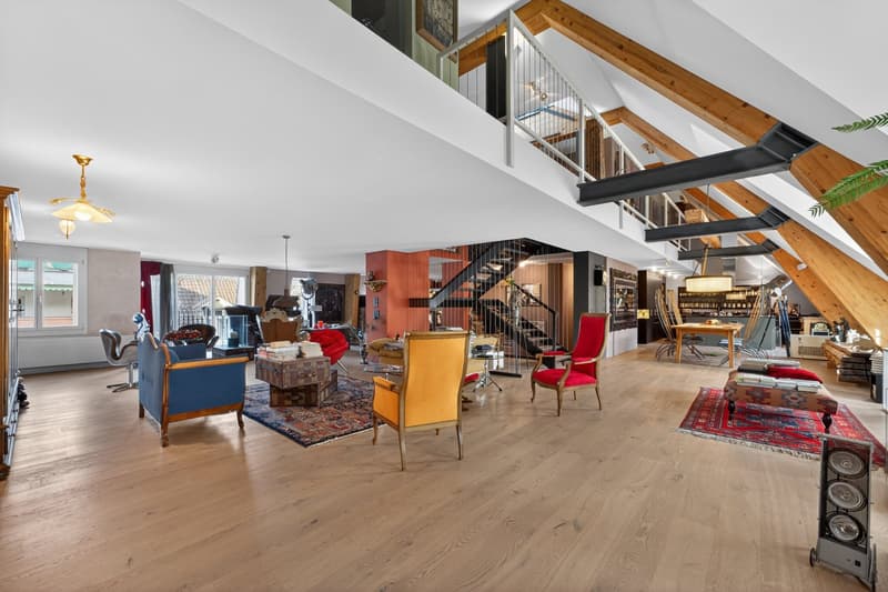 wooden floor, high ceiling, chandelier, staircase, various furniture, rugs, speaker