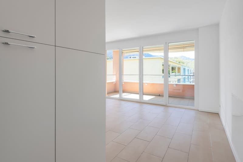 large window, balcony, tile floor, white walls