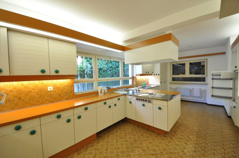 modern kitchen, white cabinets, wooden countertops, stainless steel appliances, tiled flooring, orange and white color scheme