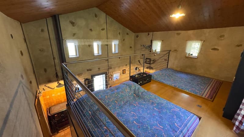 2 beds, wooden floor, 2 windows, loft with railings, hanging light, lamp