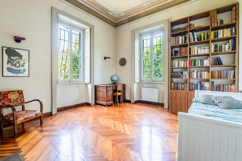 hardwood floor, bed, wooden desk, bookcase, picture on wall
