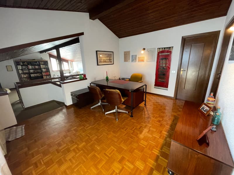 wooden floors, desk, chairs, bookshelves, framed pictures, wooden door