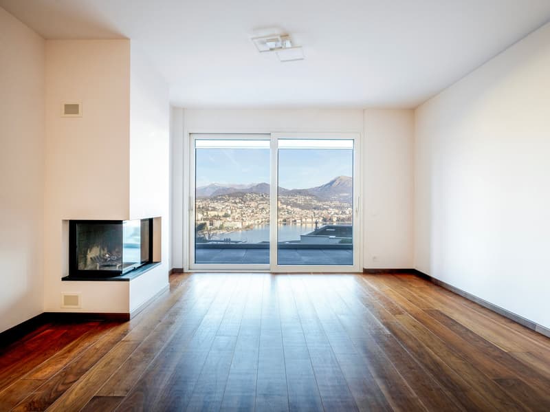 empty room, hardwood floor, fireplace, sliding glass doors, large window, balcony, scenic view